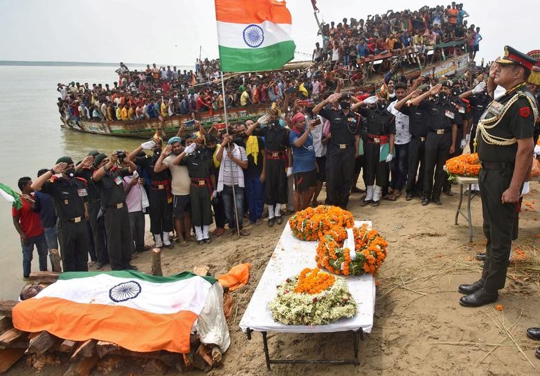 Army officers salute to pay tribute to Sunil Kumar, an Indian soldier who was killed in a border clash with Chinese troops in Ladakh region, before his cremation in Maner, in the eastern state of Bihar, India. REUTERS/Stringer